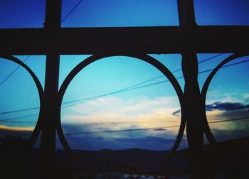 Silhouette of trees against sky at dusk