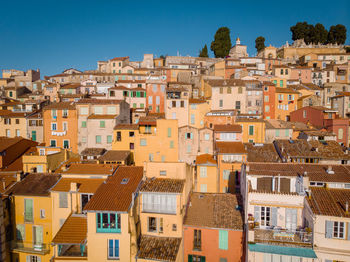 Houses in town against clear sky