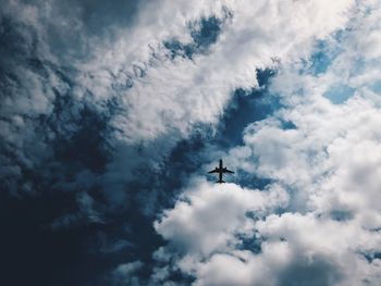 Low angle view of airplane flying in sky