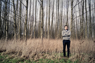 Full length of woman standing in forest