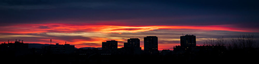 Silhouette buildings against sky during sunset