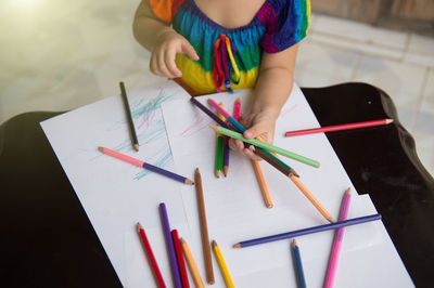 High angle view of child holding paper