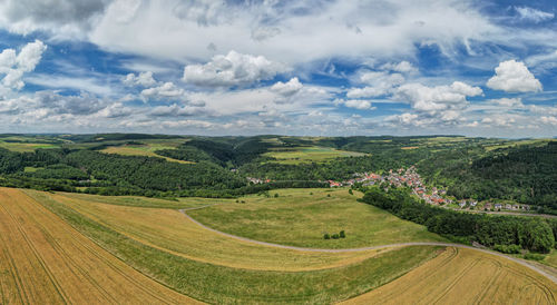 Scenic view of agricultural field against sky