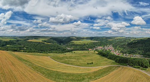 Scenic view of agricultural field against sky