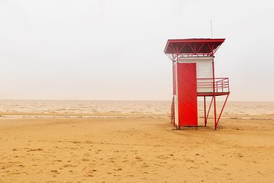 Lifeguard hut on beach against clear sky