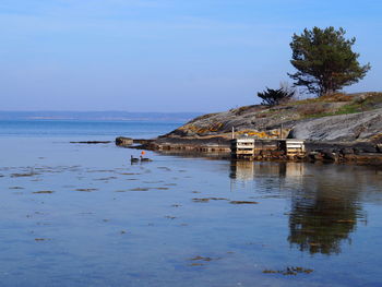 Scenic view of sea by building against sky