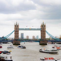 View of suspension bridge against cloudy sky