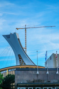 Low angle view of suspension bridge against sky