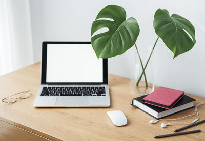 Office workplace with laptop on wooden table