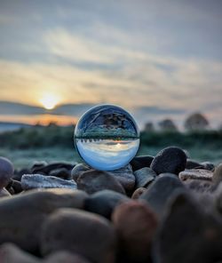 Close-up of crystal ball at beach