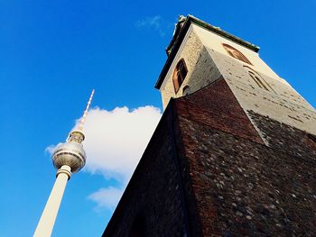 Low angle view of tower against blue sky