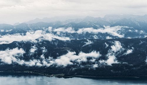 Scenic view of sea and mountains against sky