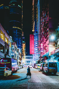 View of city street and buildings at night