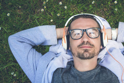 Portrait of man lying down on grass