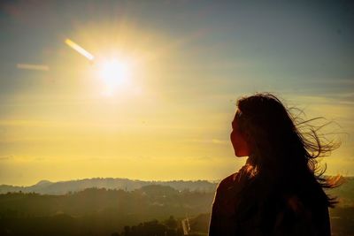 Woman against sky during sunset