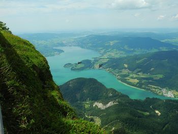 High angle view of sea and mountains against sky