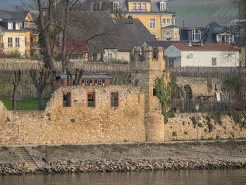 Houses by river in town