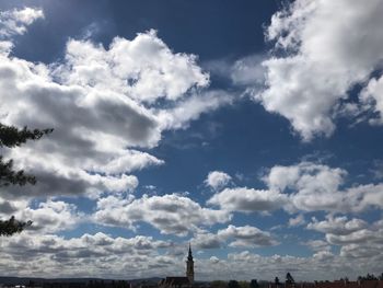 Low angle view of buildings against cloudy sky