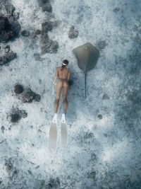 High angle view of woman standing on beach