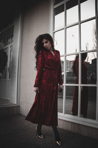 Woman standing against window