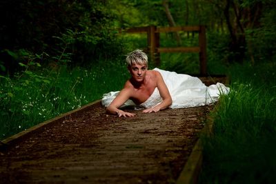 Portrait of girl sitting on wood