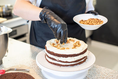 Cropped hand of person holding cake