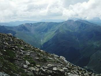 Scenic view of mountains against cloudy sky