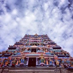 Low angle view of building against cloudy sky