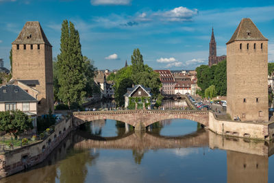 Bridge over river amidst buildings in city