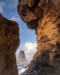 Rock formations in sea against sky