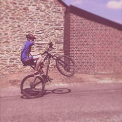 Side view of man riding bicycle