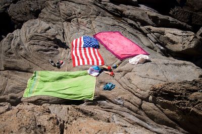 High angle view of flags on rock