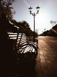 View of empty park bench on street