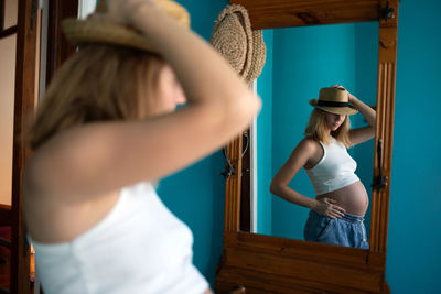 Rear view of woman standing by railing