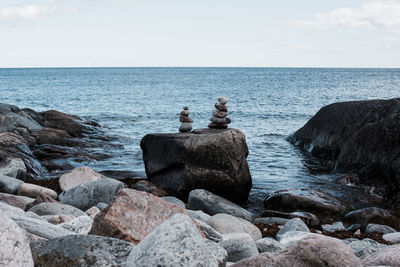 Stacked rocks by the ocean in sweden