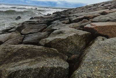 Rocks in sea against sky