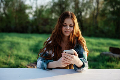 Young woman using mobile phone