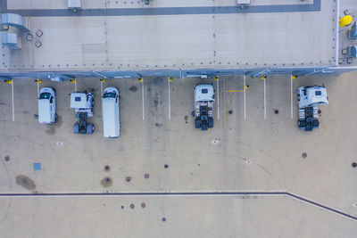 Aerial top view of the large logistics park with warehouse, loading hub with many semi-trailers .