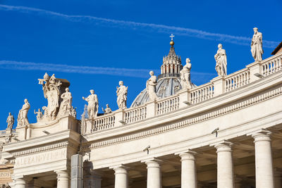 Low angle close-up of st peter basilica against vapor trails in sky