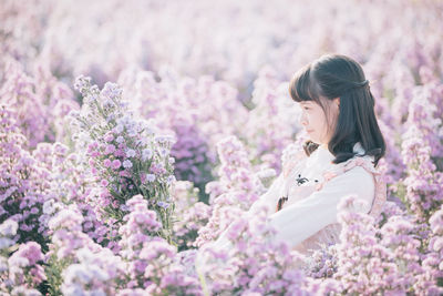 Close-up of woman with pink flowers