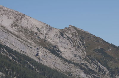 Low angle view of mountain against clear blue sky
