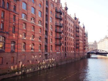 Bridge over river against buildings in city