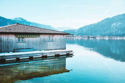 Wooden fishing house on the coast of the lake tegernsee. alpine mountains in bavaria.