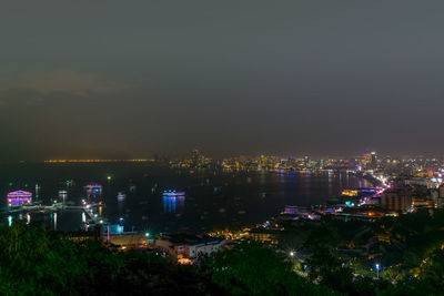 High angle view of illuminated buildings against sky at night