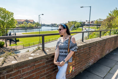 Woman standing by railing