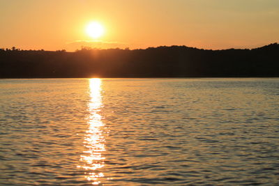 Scenic view of lake against sky during sunset