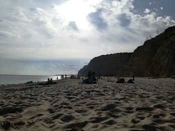 People on beach against sky