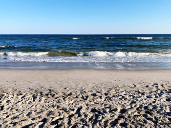 Scenic view of beach against clear sky