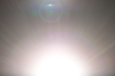 Low angle view of sun shining in sky