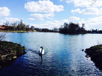 Scenic view of lake against cloudy sky